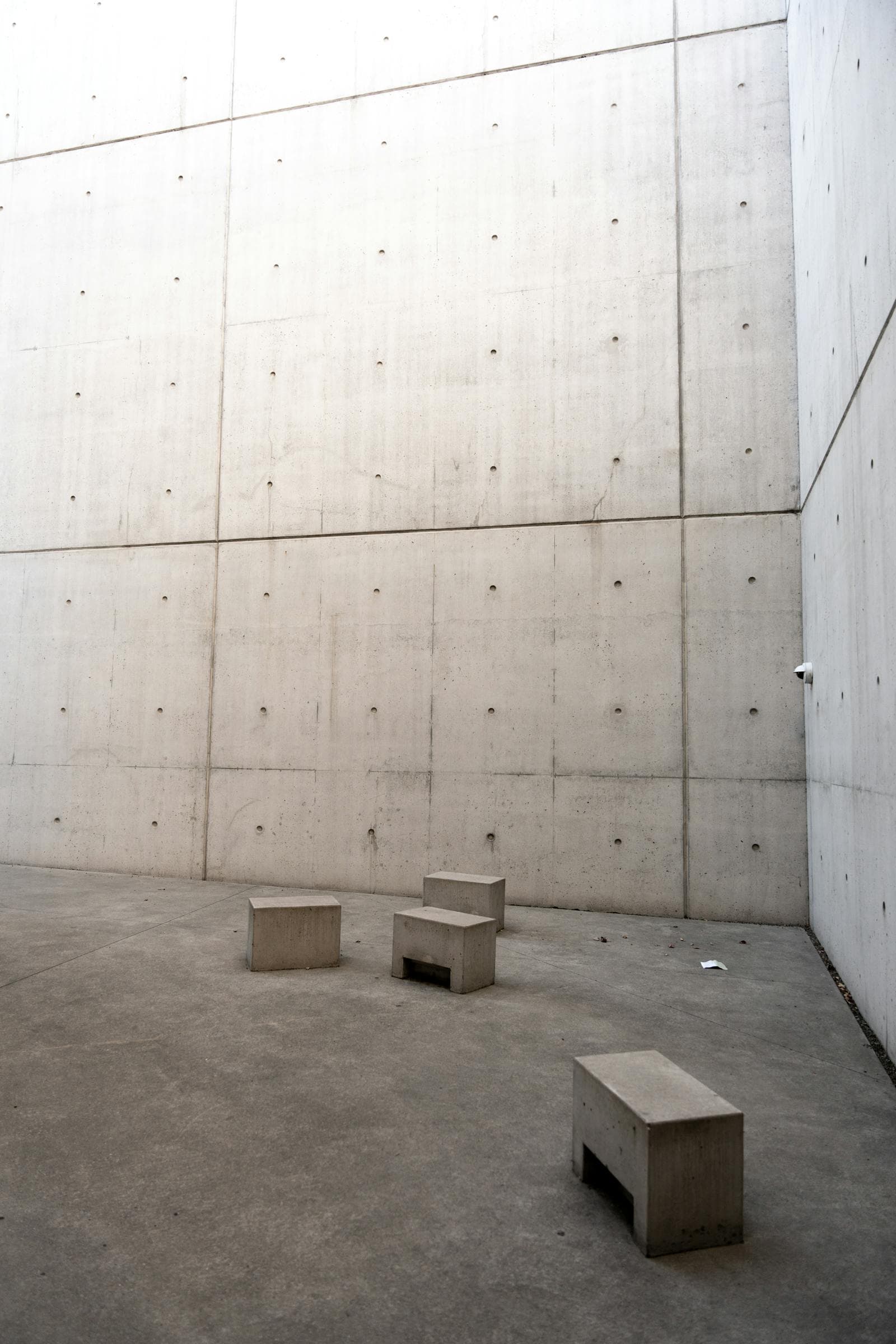 Minimalist concrete architecture — clean structural blocks, evoking a system built to hold.
